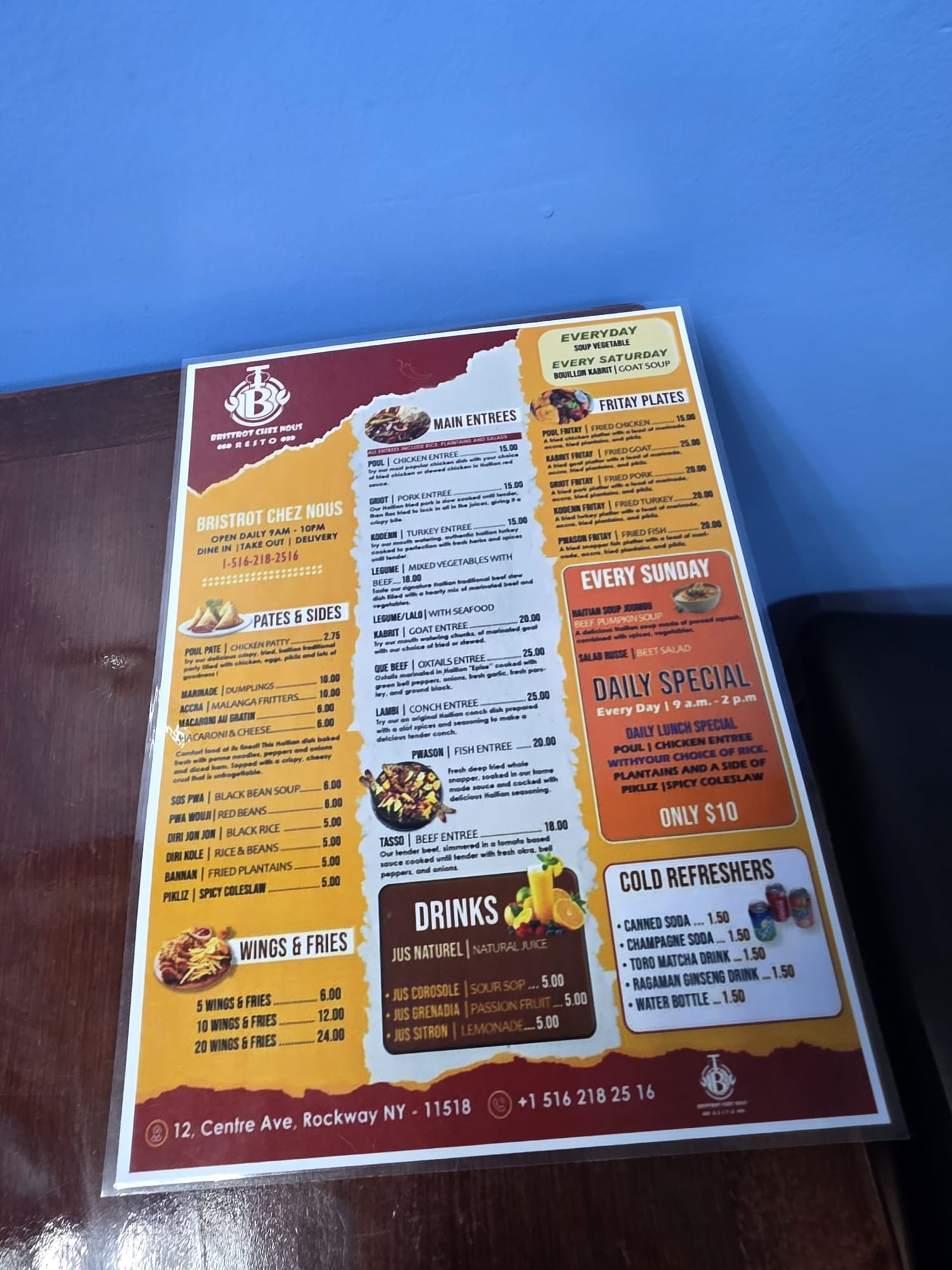 The printed menu at Bristrot Chez Nous listing Haitian breakfast, lunch and dinner dishes